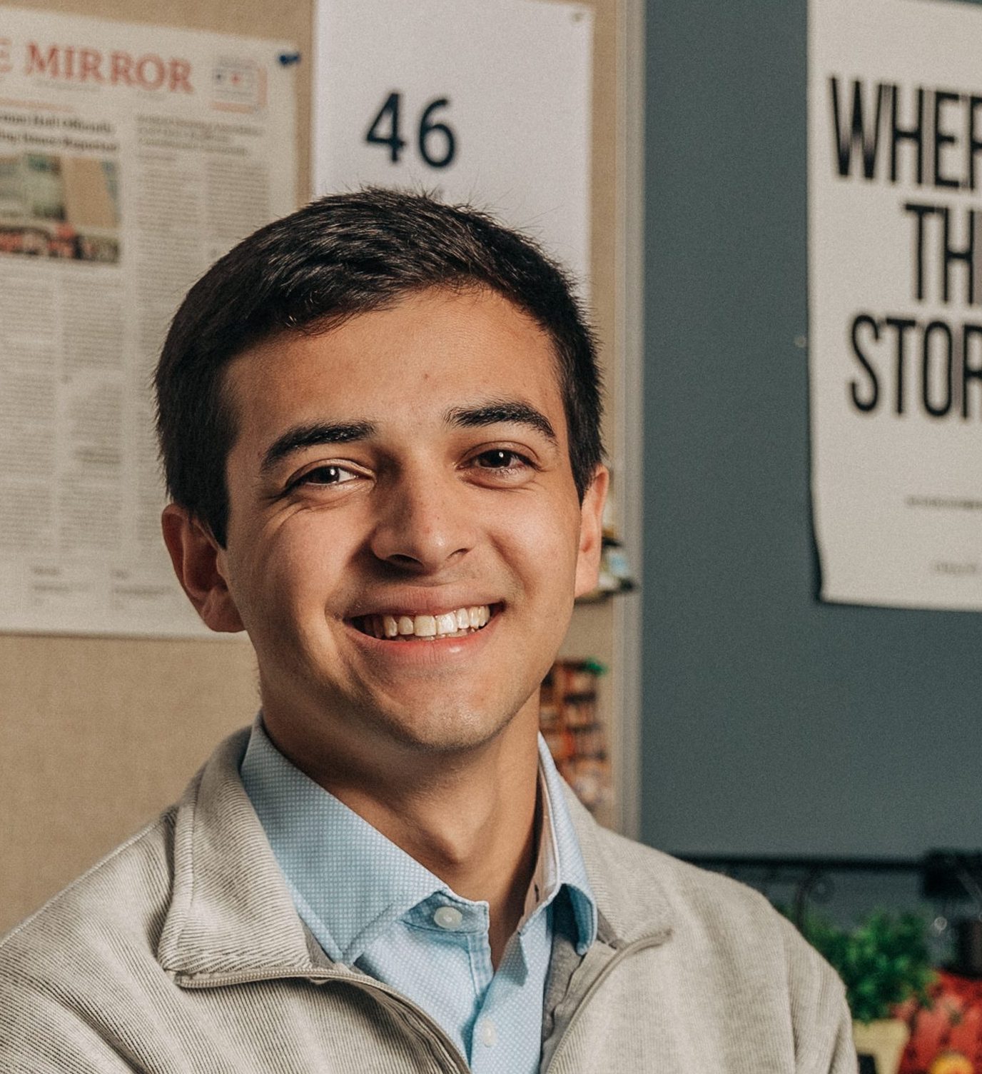 Julian Nazario poses in front of a computer inside The Mirror's office.